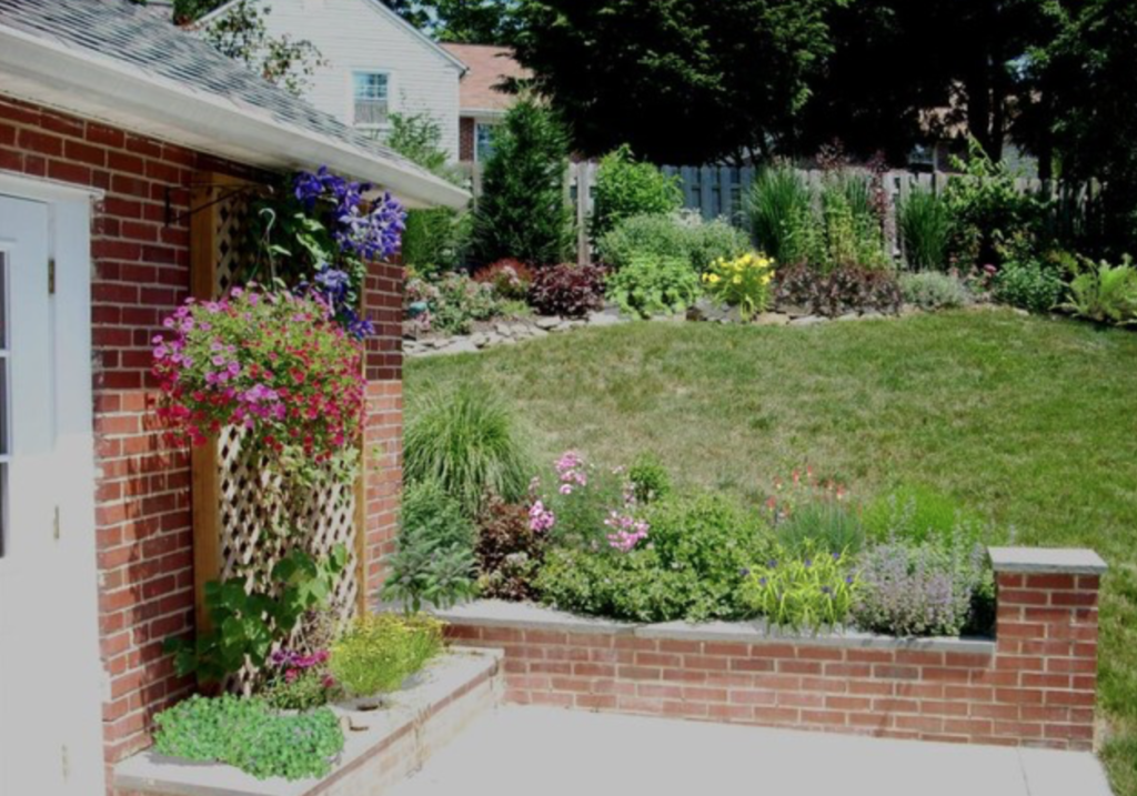 Front door surrounded by flowers