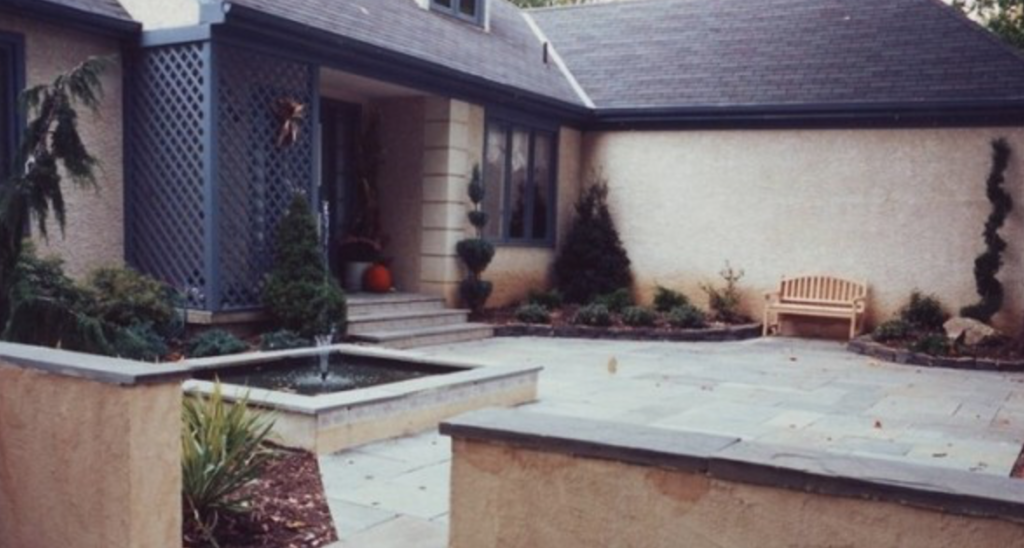 Front porch with a small landscaped fountain